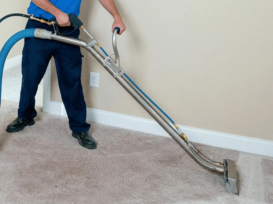 Professional operating a liquid removal machine on a carpeted floor in Savannah, GA