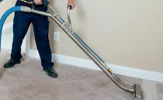 Professional operating a liquid removal machine on a carpeted floor in Savannah, GA